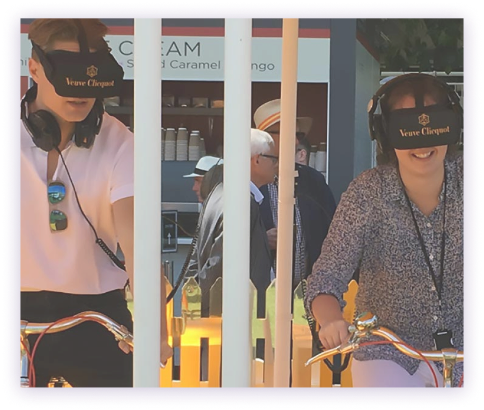 Two people on bikes with a vr headset on